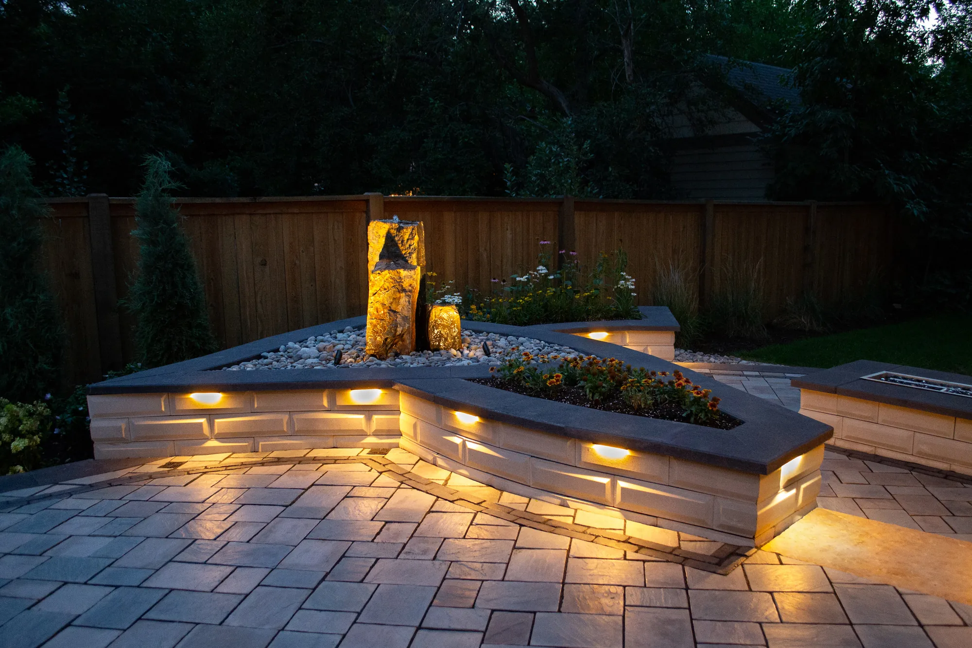 Illuminated masonry seat wall and water feature