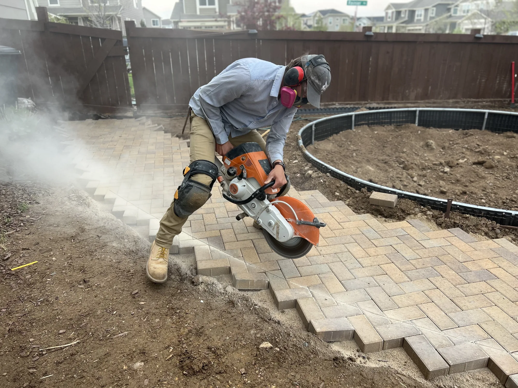 Paver cutting during courtyard installation