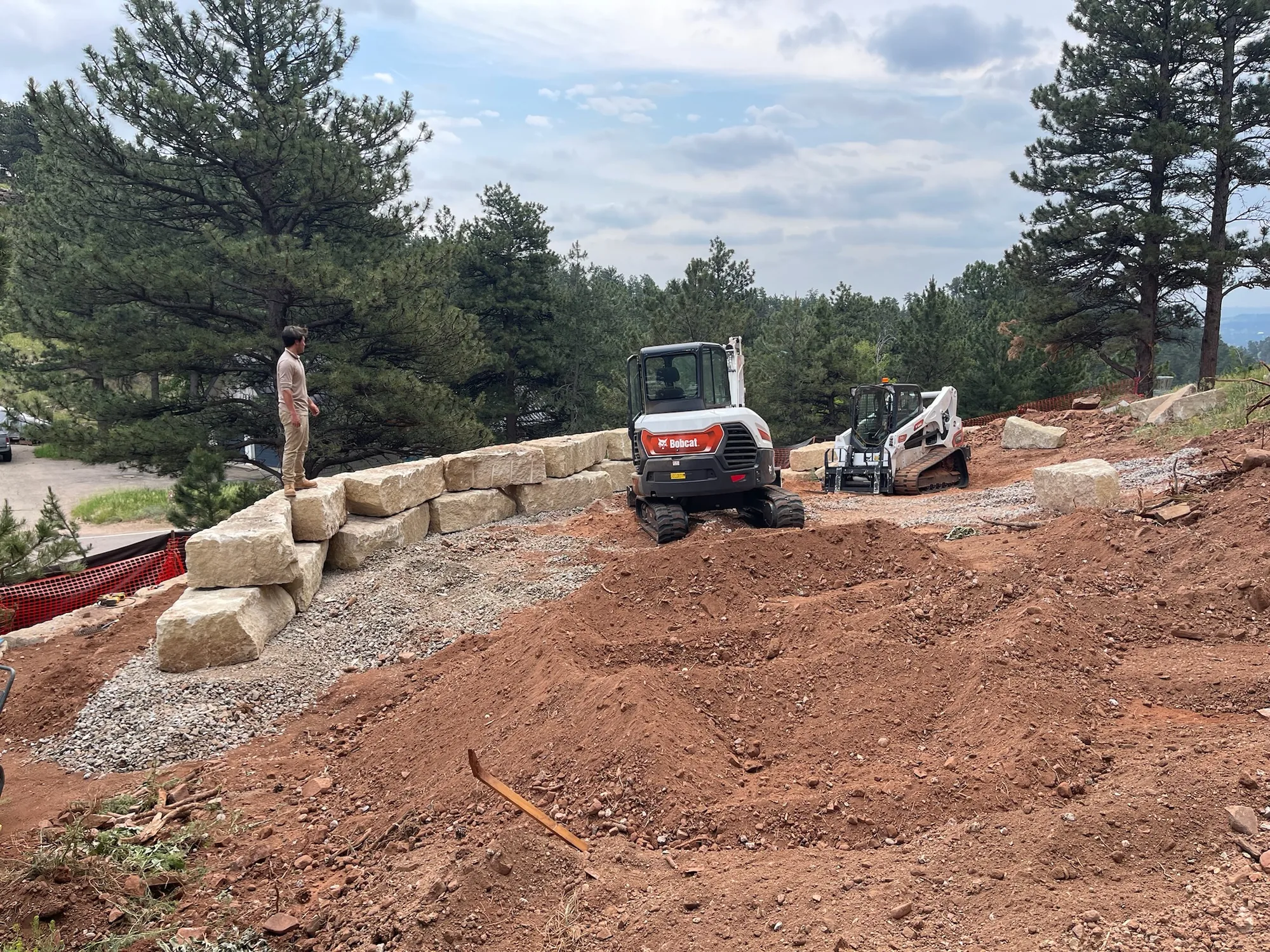 Hillside retaining wall base during excavation