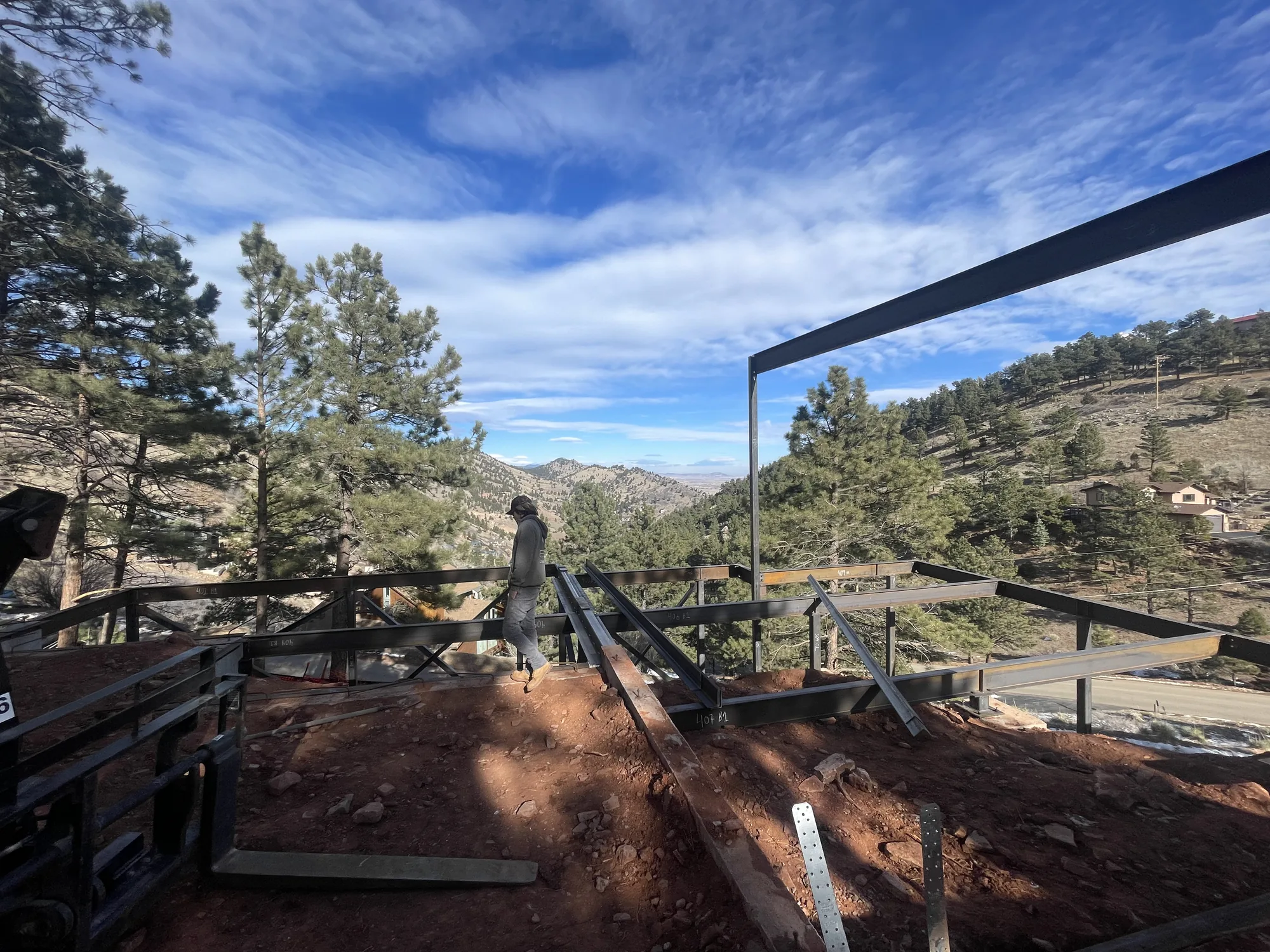 Steel beam installation above a mountain terrace