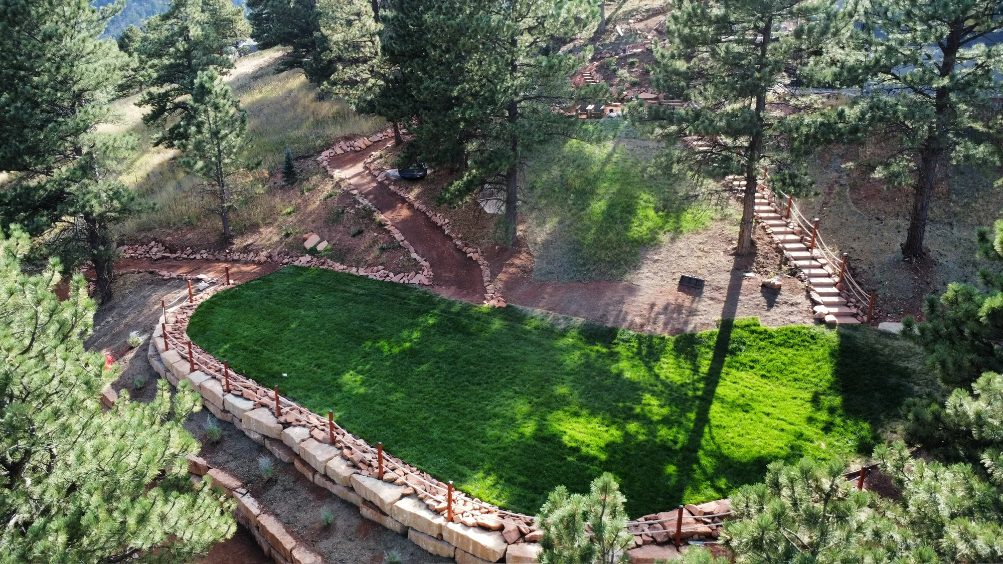 Aerial view of landscape construction across a steep wooded site