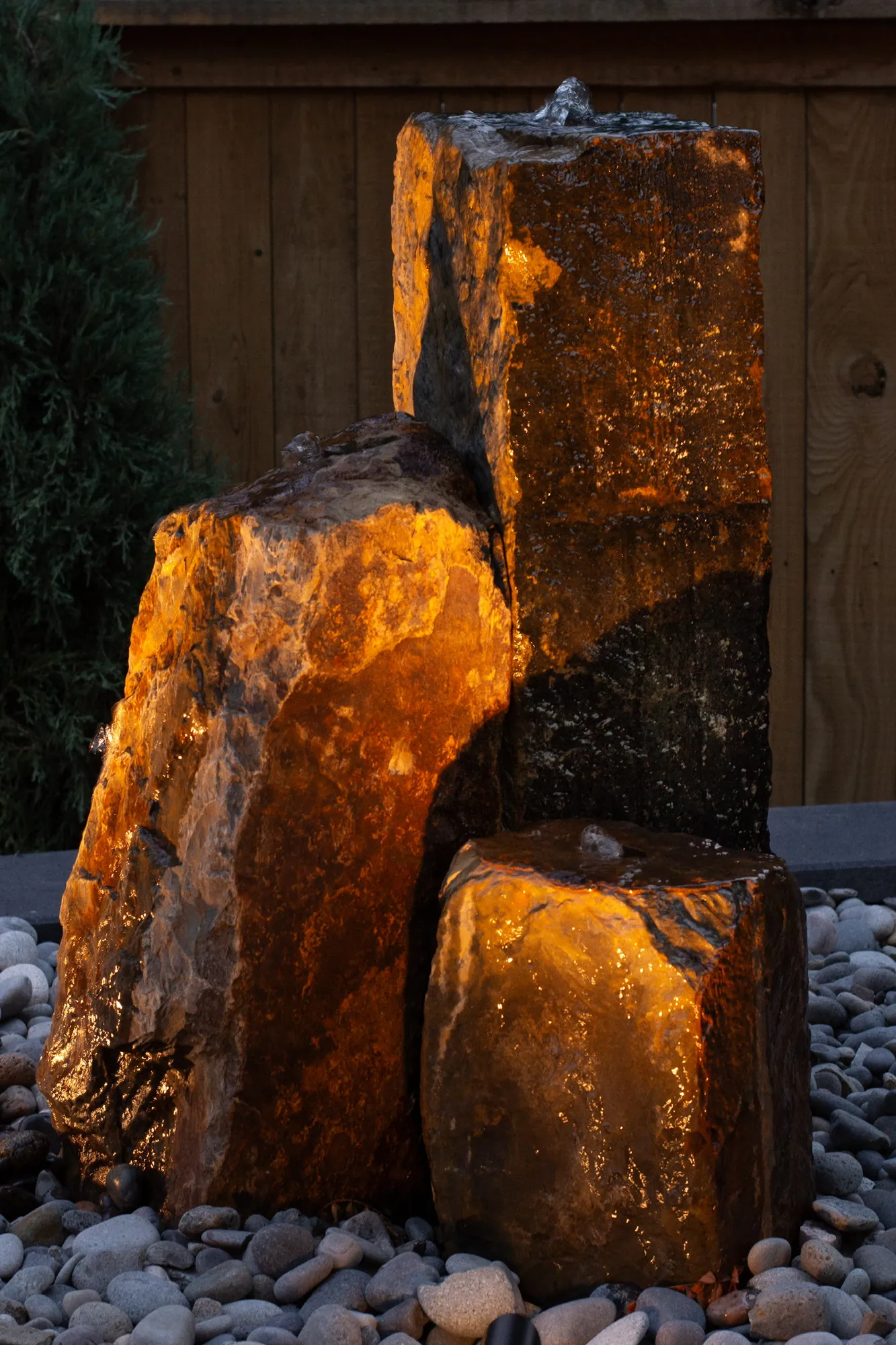 Illuminated stone water feature at Oak Street