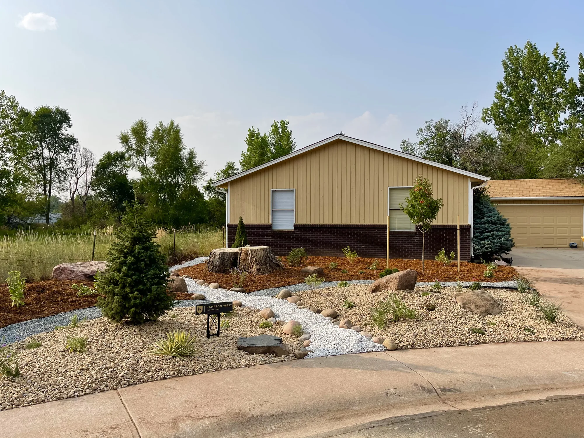 Completed dry creek and layered front-yard planting