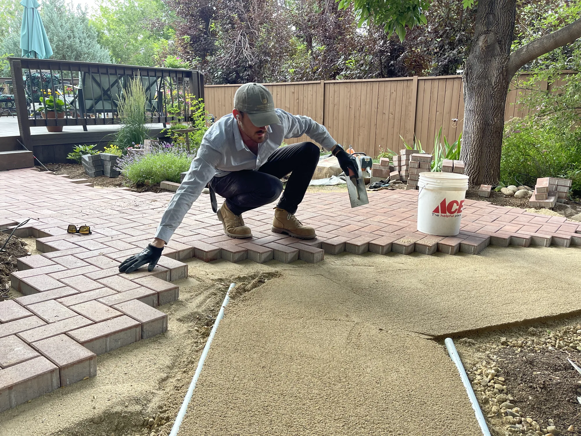 Brick pavers being set along a curved patio edge